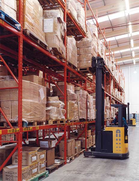 man moving boxes in warehouse